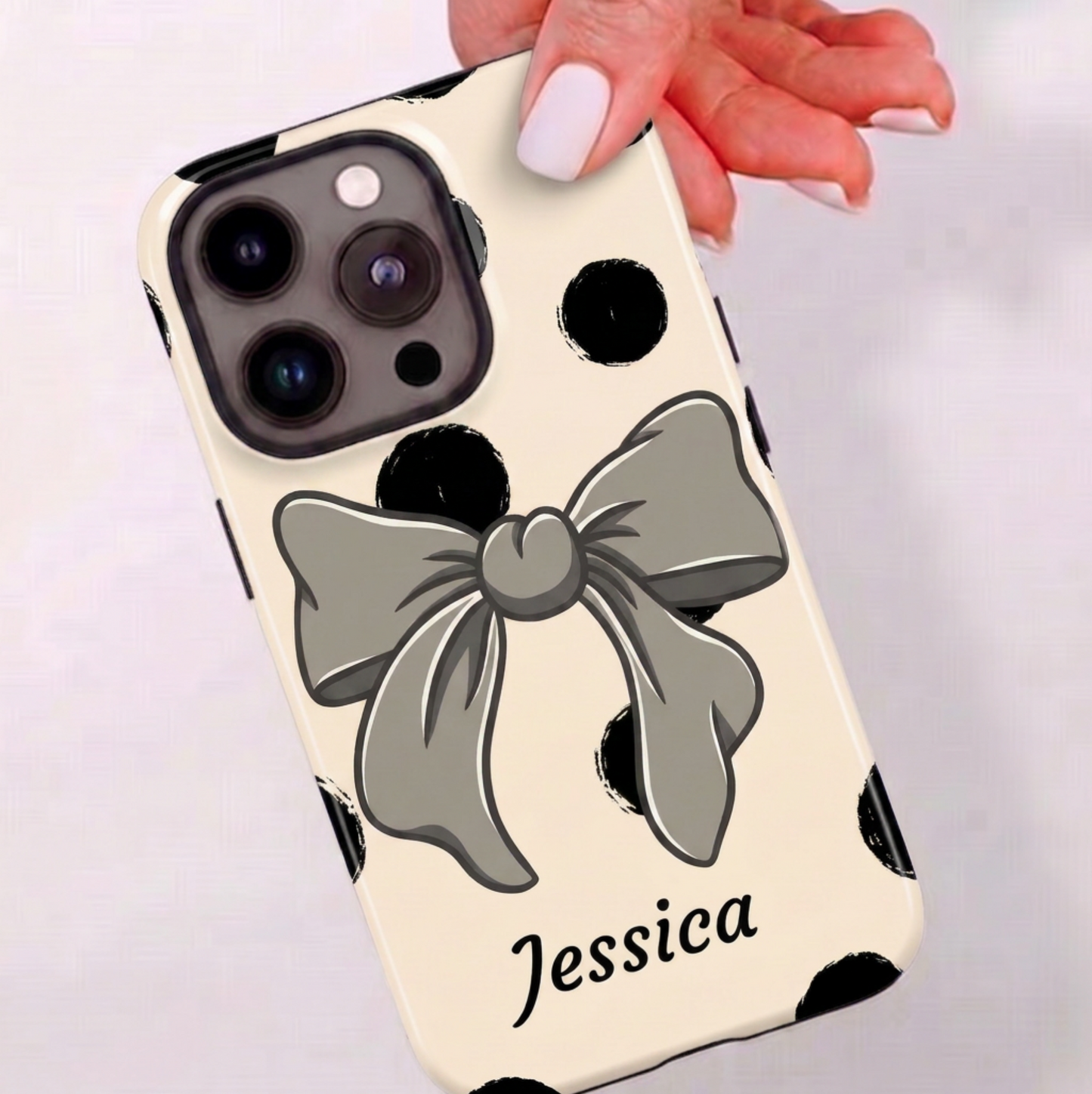 Phone case with a bow design and the name 'Jessica' on a white background