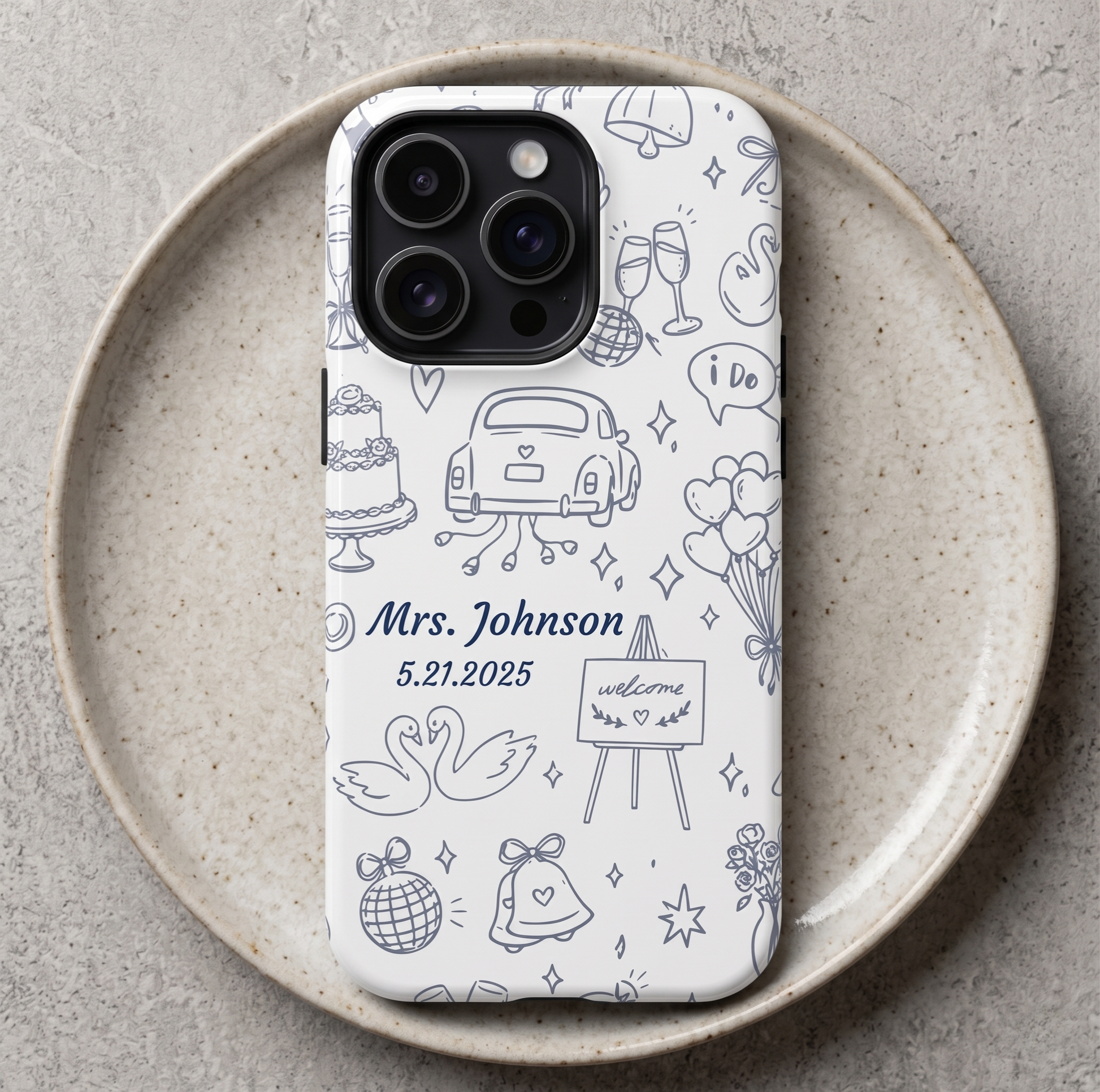 Custom bride phone case in navy blue with hand-drawn wedding icons including cake, getaway car, swans and bells personalized with name and date