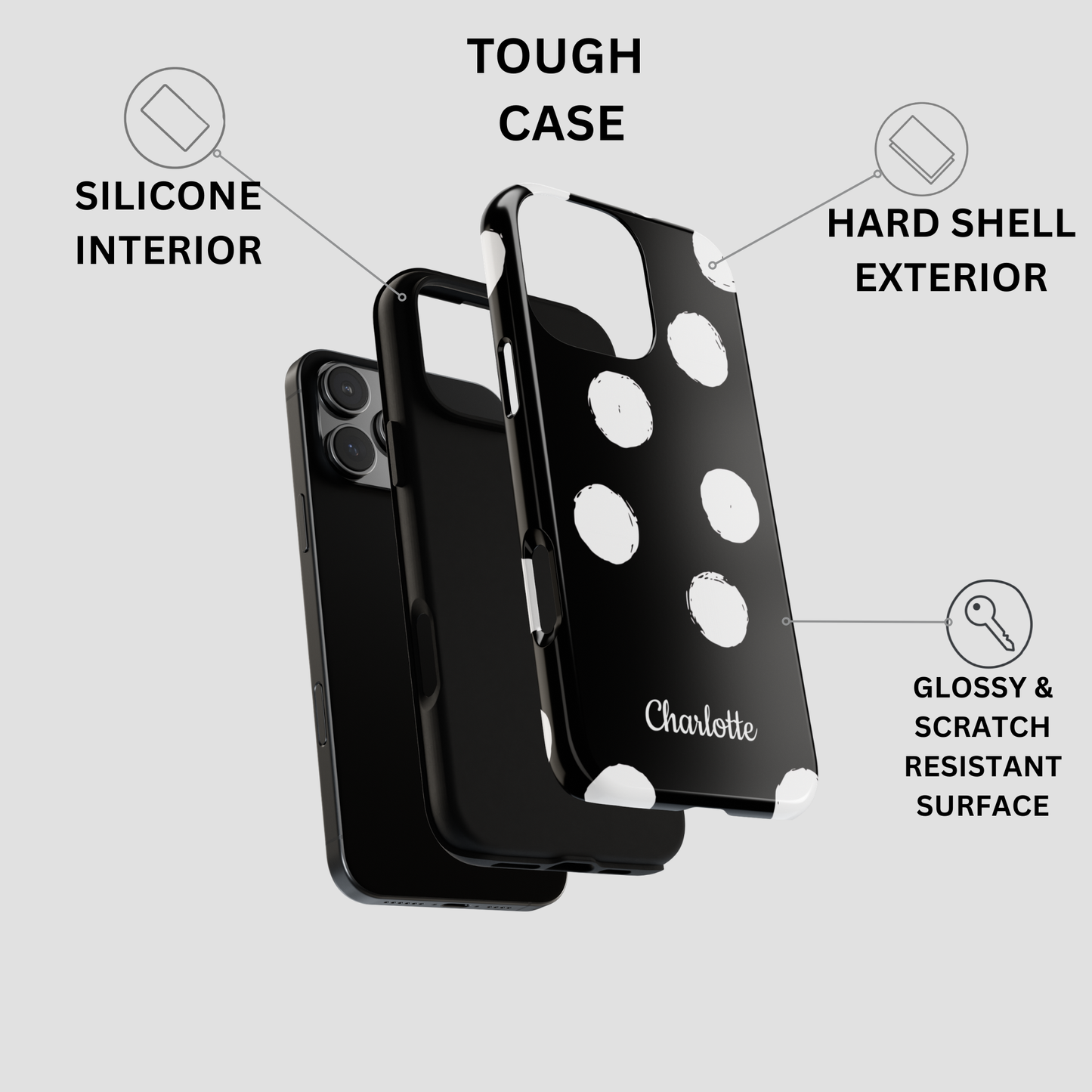 Black phone case with white polka dots and the name 'Charlotte' printed on the back, shown with callout labels for tough case features on a light gray background.