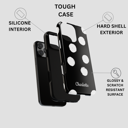 Black phone case with white polka dots and the name 'Charlotte' printed on the back, shown with callout labels for tough case features on a light gray background.