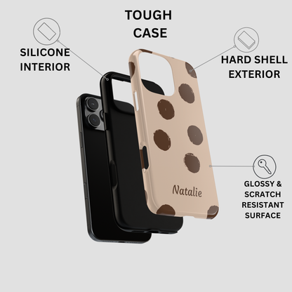 A brown phone case with dark brown polka dots and the name 'Natalie' printed on it, shown alongside a black phone. The image includes text callouts describing the tough case design, silicone interior, hard shell exterior, and glossy scratch-resistant surface.