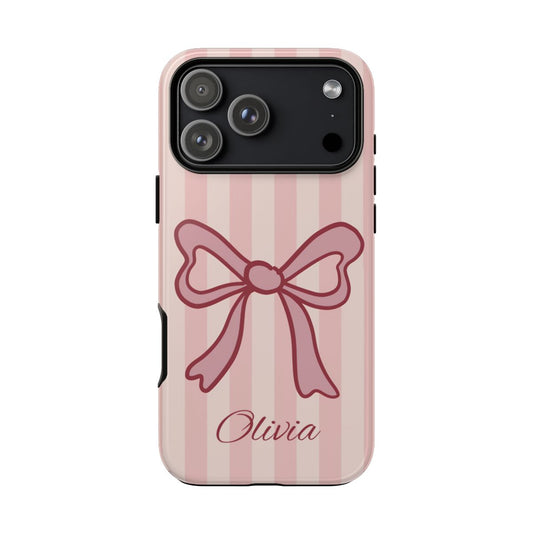 Personalized pink coquette bow phone case with the custom name  on a soft striped background.