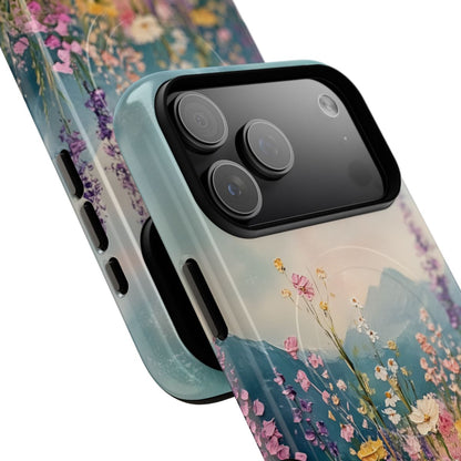 Artistic mountain scene phone case design with a lush foreground of blooming flowers and distant peaks.