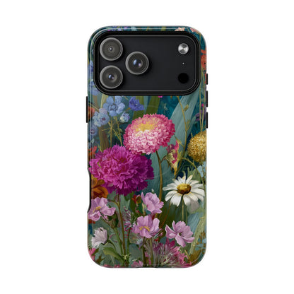 A smartphone protected by a hard-shell case featuring a vibrant, full-coverage floral illustration with pink zinnias, white daisies, and purple wildflowers against a dark teal background.