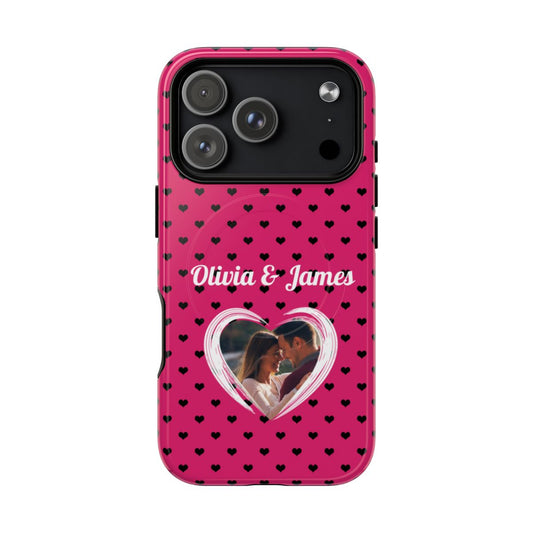 Personalized hot pink phone case with a black heart pattern and a custom photo of a couple in a large central heart.